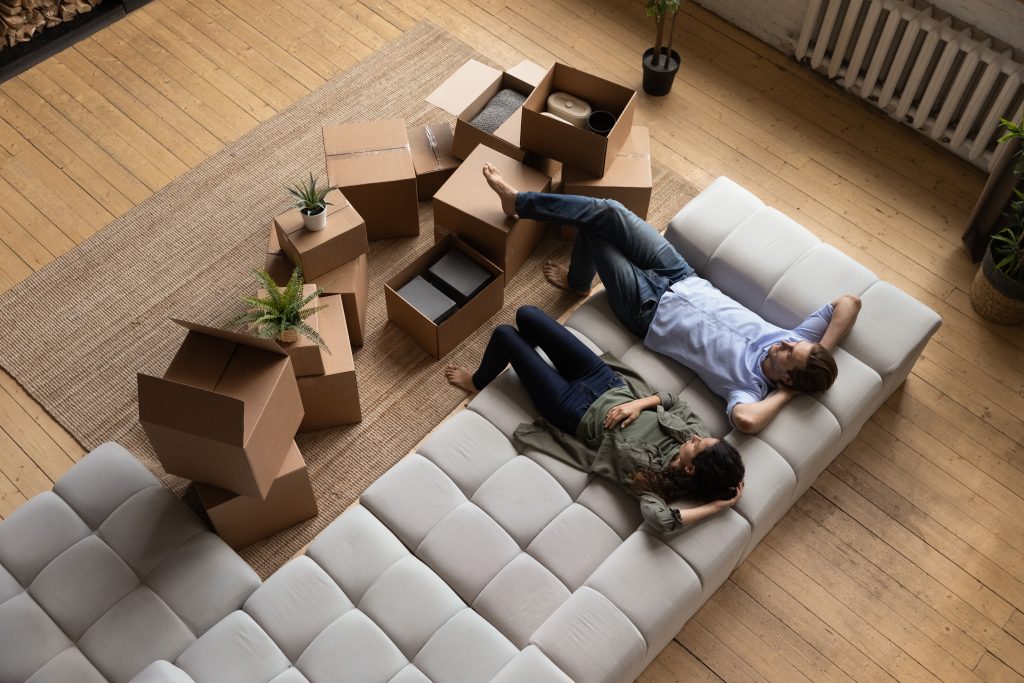A top view of a tired couple moving in to an apartment or home.