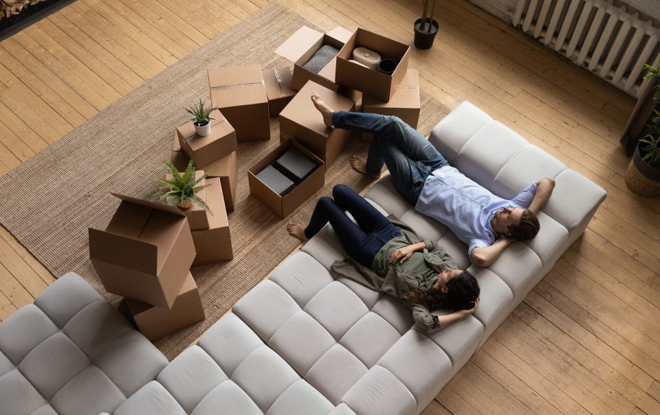 A top view of a tired couple moving in to an apartment or home.
