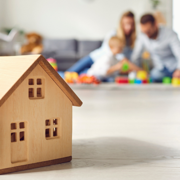 home in focus while family plays in background