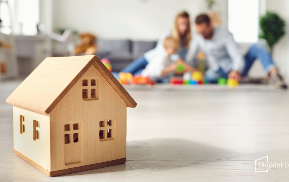 home in focus while family plays in background