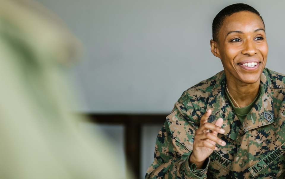 female marine sitting in chair smiling