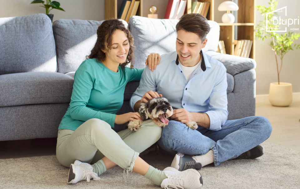 woman and man sitting on floor with dog